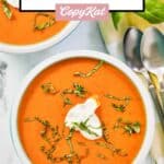 Homemade La Madeleine red pepper soup in two bowls and two spoons.