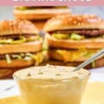 A bowl of homemade big mac sauce and big mac burgers behind it.