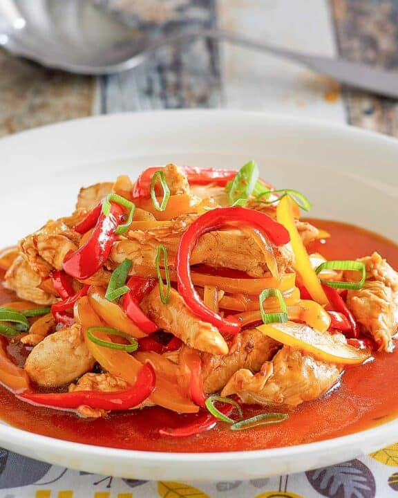 Copycat Panda Express firecracker chicken in a bowl and a spoon behind it.