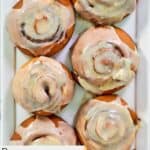 Six homemade Panera cinnamon rolls on a platter.