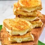 Copycat Starbucks grilled cheese sandwiches on a wood board.