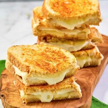 Copycat Starbucks grilled cheese sandwiches on a wood board.