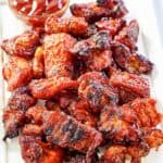 Copycat Applebee's riblets and a small cup of barbecue sauce on a platter.