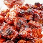 Homemade Applebee's riblets and a small cup of bbq sauce.