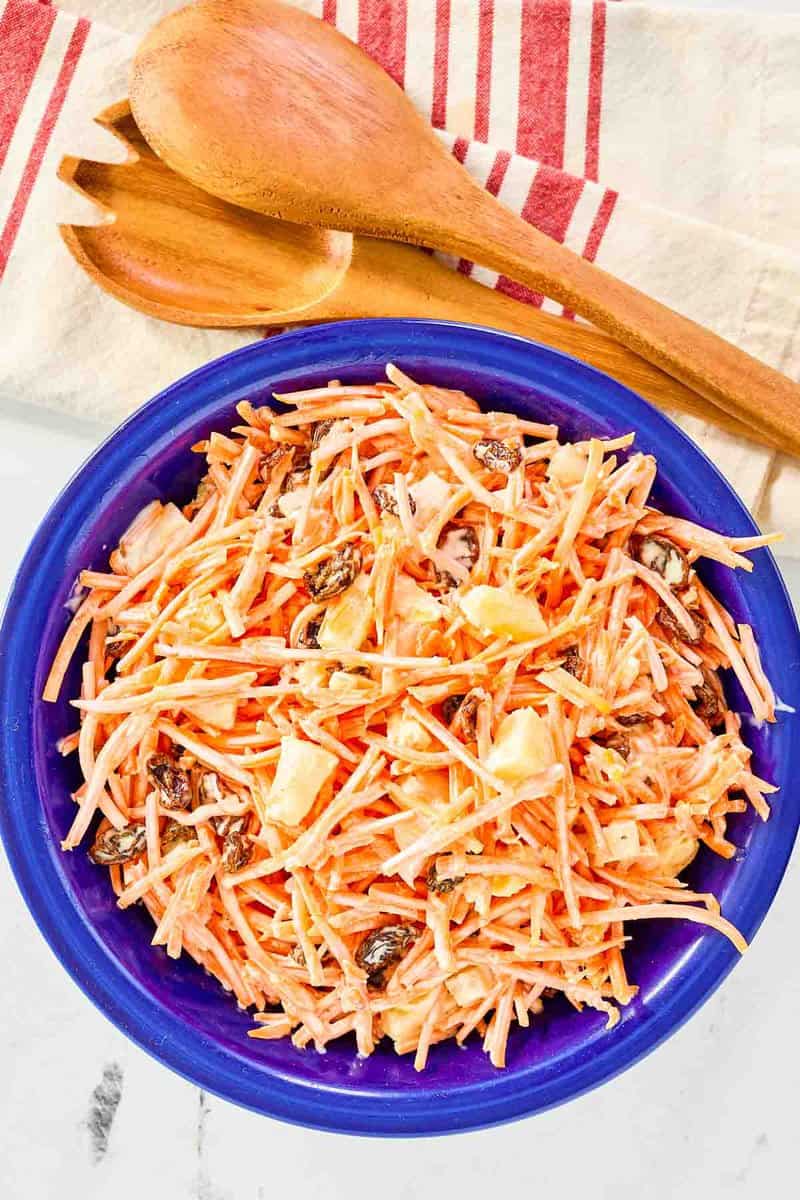 Copycat Chick Fil A carrot raisin salad and wooden serving spoons.