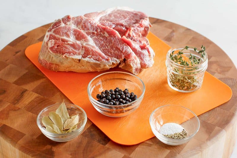 Copycat Chipotle carnitas ingredients on a wood board.