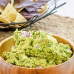 Copycat Chipotle guacamole in a wood bowl.