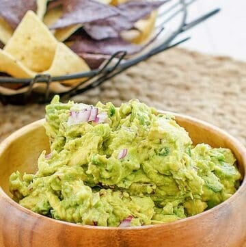 Copycat Chipotle guacamole in a wood bowl.
