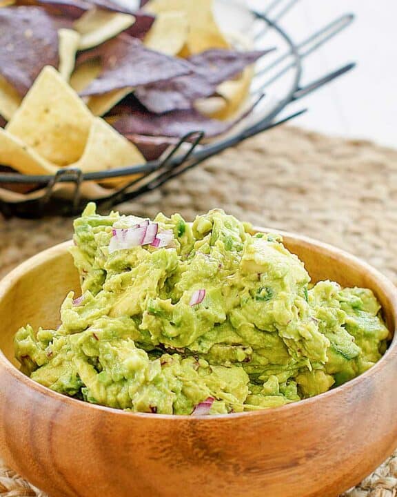Copycat Chipotle guacamole in a wood bowl.