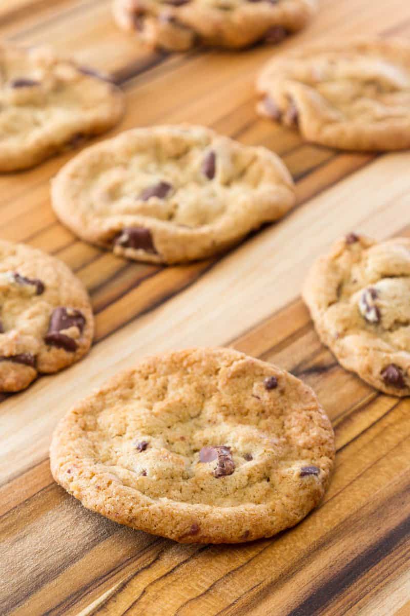 Homemade chocolate chippers on a wood board.
