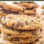 A bunch of chocolate chippers on a wood board.