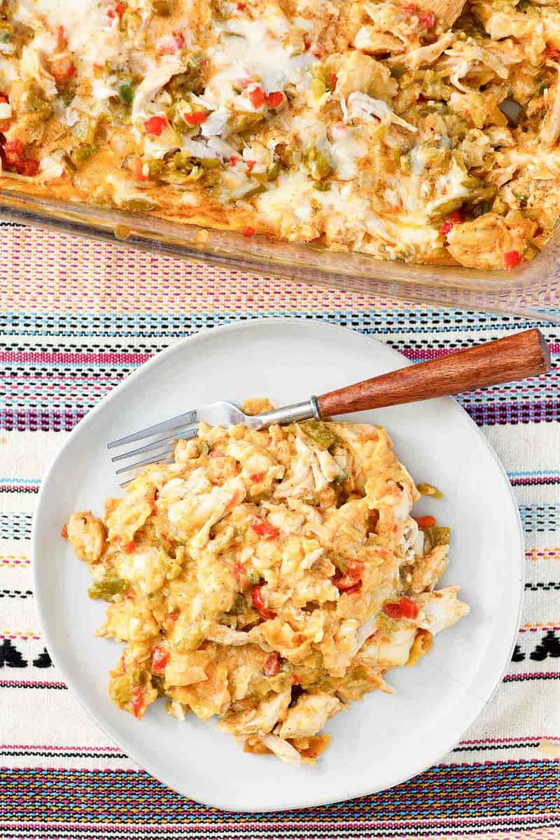 King ranch casserole serving on a plate and the casserole beside it.