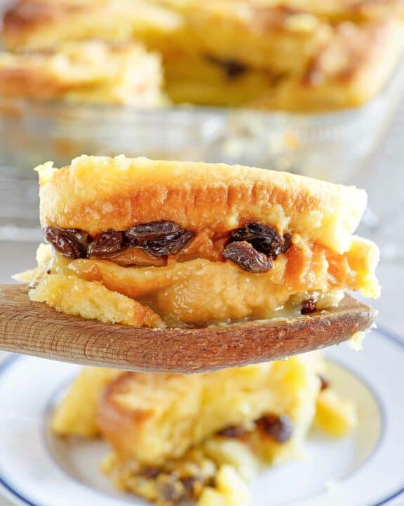Copycat Raglan Road bread pudding serving on a wooden spoon.