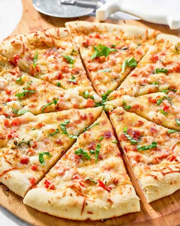 Copycat Red Lobster lobster pizza and a pizza cutter.