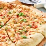 Homemade Red Lobster lobster pizza and a pizza cutter.