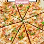 Sliced homemade Red Lobster lobster pizza on a pizza peel.