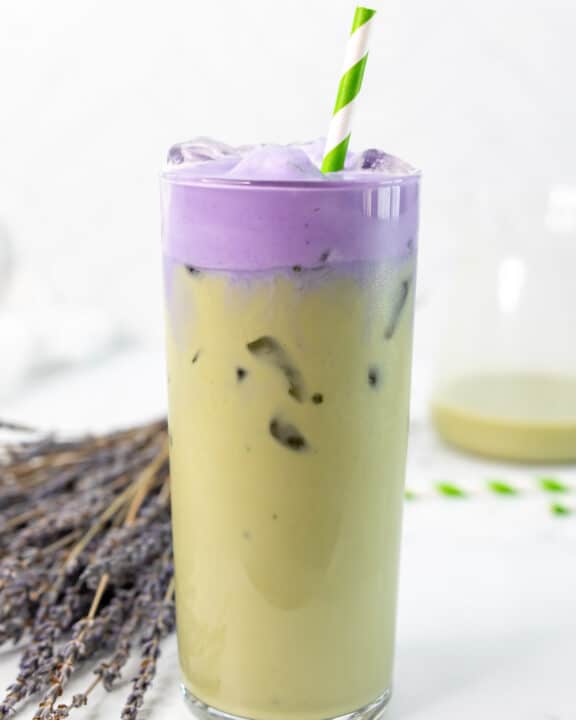 Copycat Starbucks iced lavender cream oatmilk matcha in a glass with a straw.