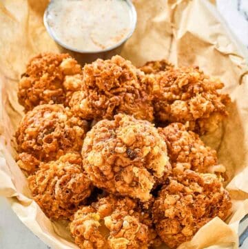Copycat Texas Roadhouse rattlesnake bites and cajun sauce in a serving basket.