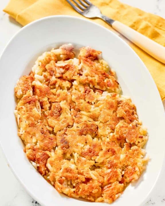 Copycat Waffle House hash browns and a fork on a napkin.