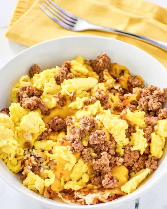 Copycat Waffle House sausage, egg, and cheese hashbrown bowl.
