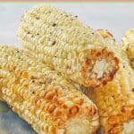 Air fried corn cobs on a plate.