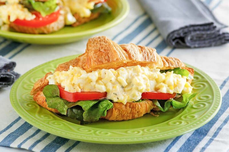 Copycat chicken salad chick egg salad sandwich on a plate.