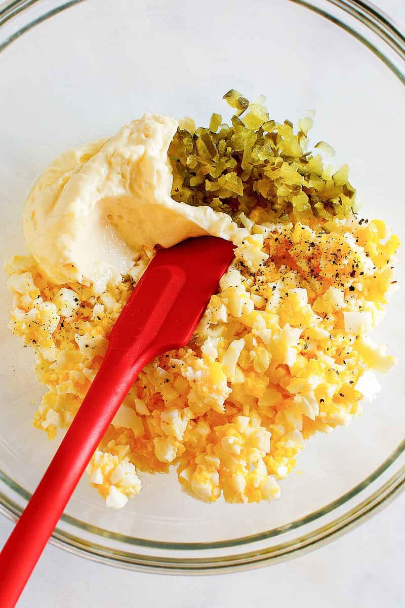 Copycat chicken salad chick egg salad ingredients in a bowl.