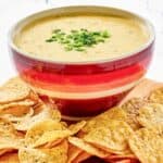 Homemade Chipotle queso blanco, tortilla chips, and red pepper strips.