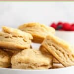 Homemade freezer biscuits piled on a plate.