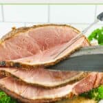 Cutting slices off a homemade honey baked ham.