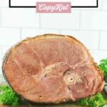 Copycat honey baked ham on a wood cutting board.