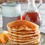 Copycat IHOP country griddle cakes topped with syrup on a plate.
