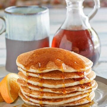 Copycat IHOP country griddle cakes topped with syrup on a plate.