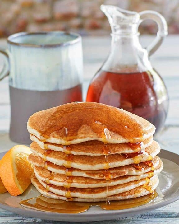 Copycat IHOP country griddle cakes topped with syrup on a plate.