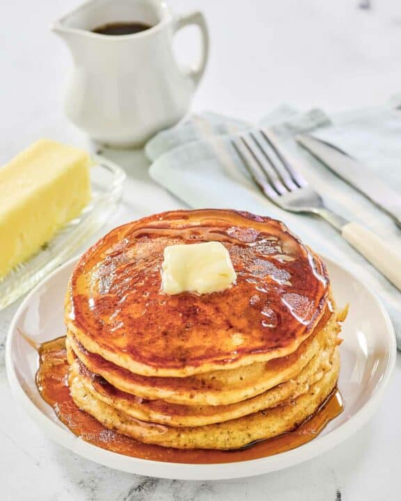 Copycat IHOP protein pancakes topped with butter and syrup.