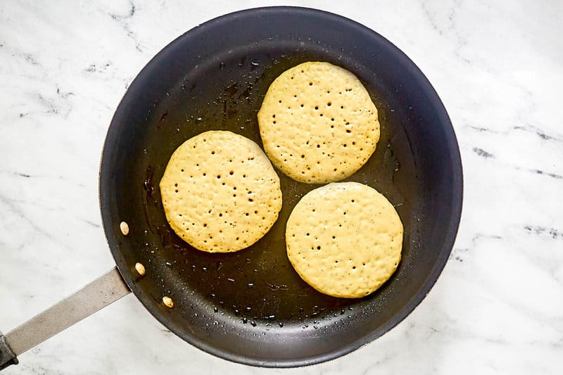 Cooking copycat IHOP protein pancakes in a skillet.