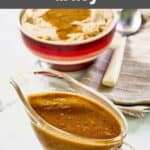 Homemade KFC gravy in a gravy boat and over mashed potatoes.