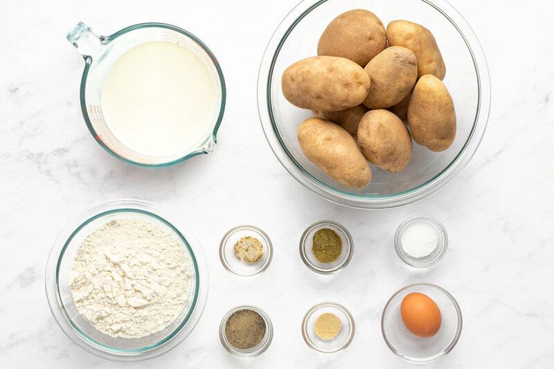 Copycat KFC potato wedges ingredients on a marble surface.