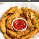 Homemade KFC potato wedges and a cup of ketchup in a serving basket.