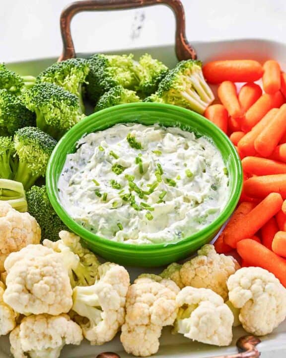 Copycat Melting Pot green goddess dip and fresh vegetables on a tray.