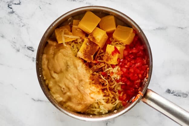 Copycat Red Lobster ultimate fondue ingredients in a pan.