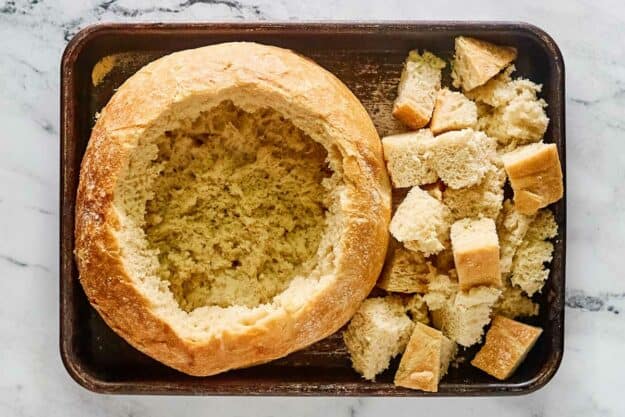 Hollowed out bread loaf and bread cubes.