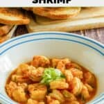 Homemade Ruth's Chris barbecue shrimp in a bowl and toasted bread behind it.