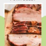 Smoked pork belly slices on a wood cutting board.