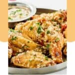 Homemade Buffalo Wild Wings parmesan garlic wings and sauce on a platter.