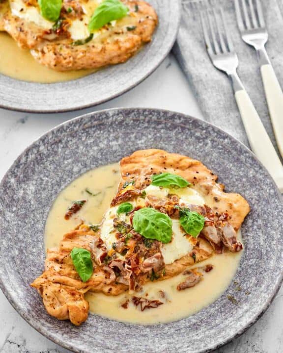 Copycat Carrabba's chicken bryan on two plates.