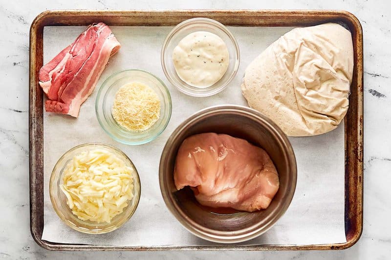 Copycat Costco chicken bake ingredients on a tray.
