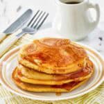 Copycat McDonald's pancakes with buttery maple syrup on a plate.