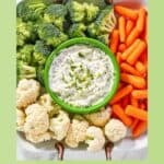 Copycat melting pot green goddess dip and raw vegetables around it.