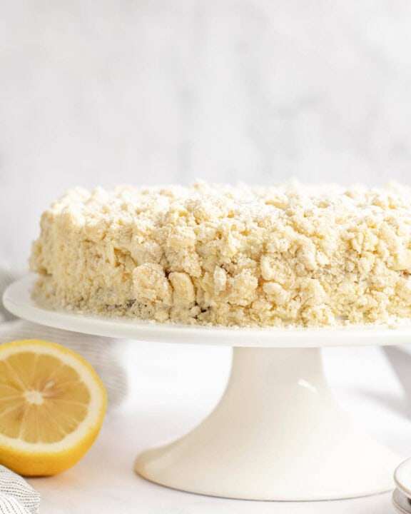 Copycat Olive Garden lemon cream cake on a cake stand.